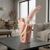 Lifestyle pink ceramic modern art flower vase placed on center table in living room aesthetic home decor styling idea.