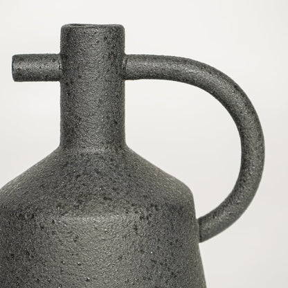 Black ceramic decorative vase with textured stone finish and handle design perfect for elegant dried floral display and interior decor.