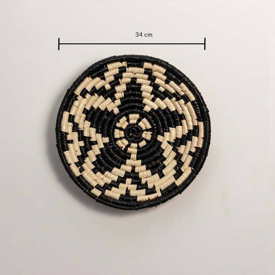 Dimension image of handcrafted black cream seagrass wall basket with geometric star pattern for bedroom boho wall décor.