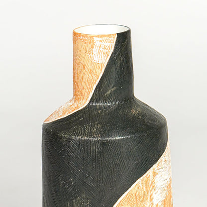 Close view of orange and black ceramic vase highlighting textured finish sculpted neck and modern artistic form.