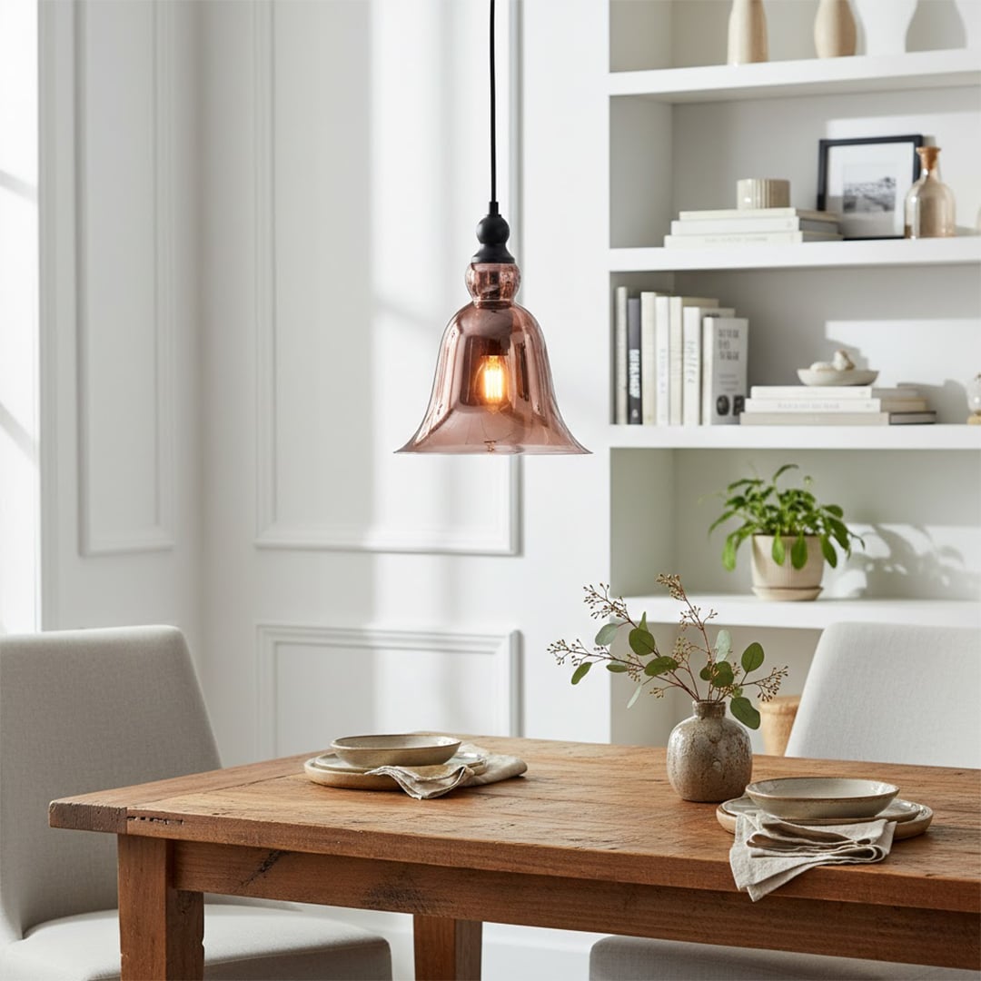 Black metal pendant light with amber glass shade illuminating dining area with vintage charm.