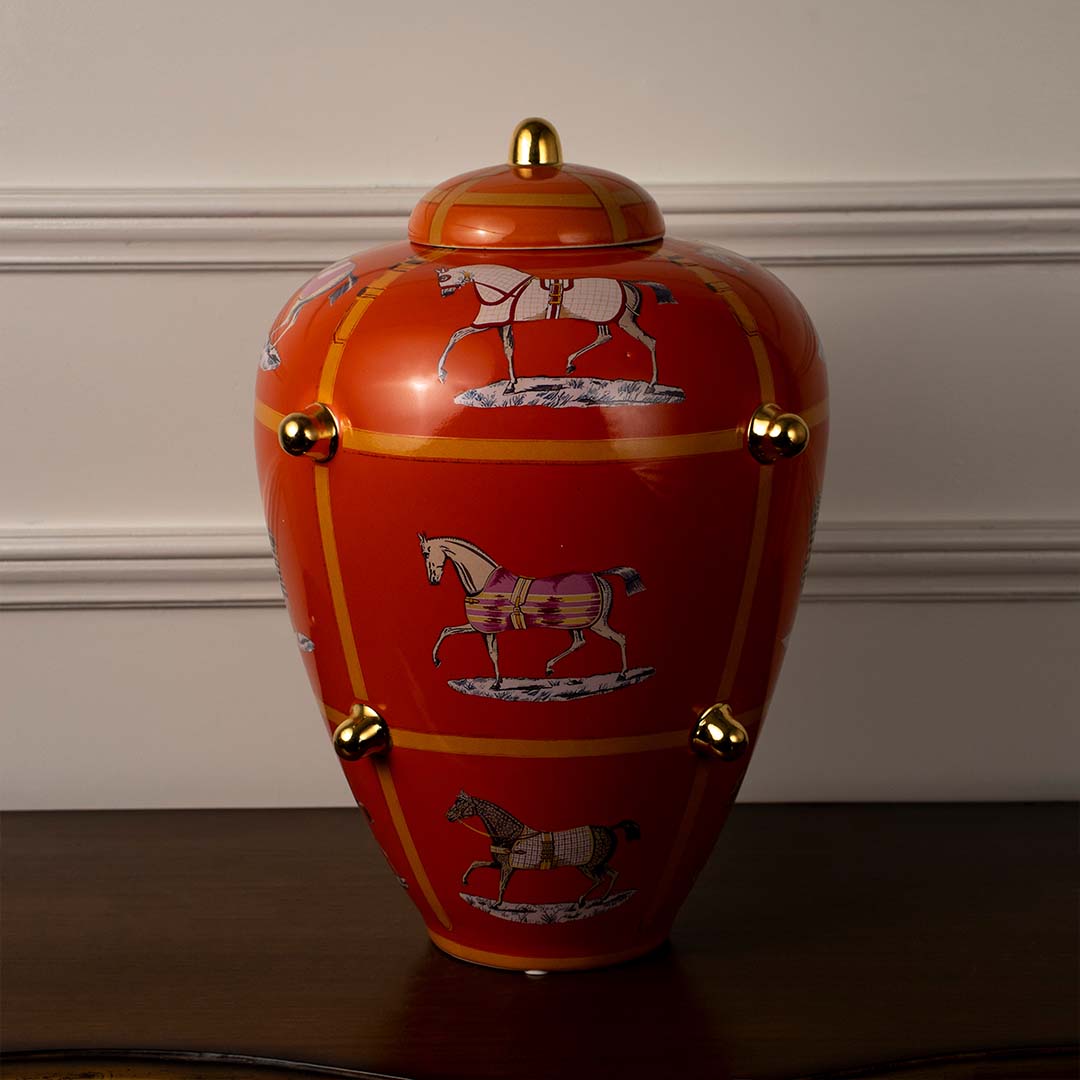 White background image ceramic ginger jar orange vase with golden detailing and horse artwork perfect home decoration.