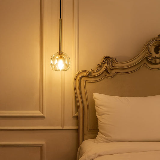 Elegant crystal pendant light with golden stem illuminating a cozy modern space adding luxury and sophistication to interiors.