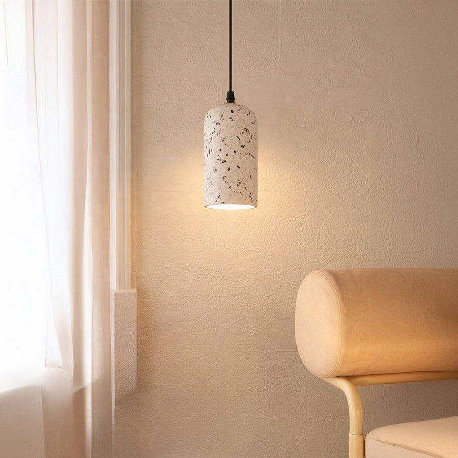 White terrazzo pendant light with black flecks illuminating cozy corners with soft contemporary elegance.