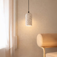White terrazzo pendant light with black flecks illuminating cozy corners with soft contemporary elegance.