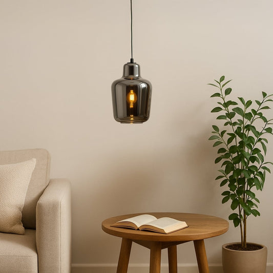 Modern smoked-glass pendant light styled in a warm lifestyle setting showcasing its reflective finish and elegant rounded silhouette.