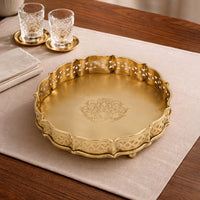 Antique gold metal serving tray placed on a dining table adding luxurious charm and elegant tabletop styling.