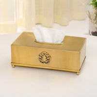 Antique gold metal tissue box holder placed on a tabletop adding luxurious charm and refined decor appeal.