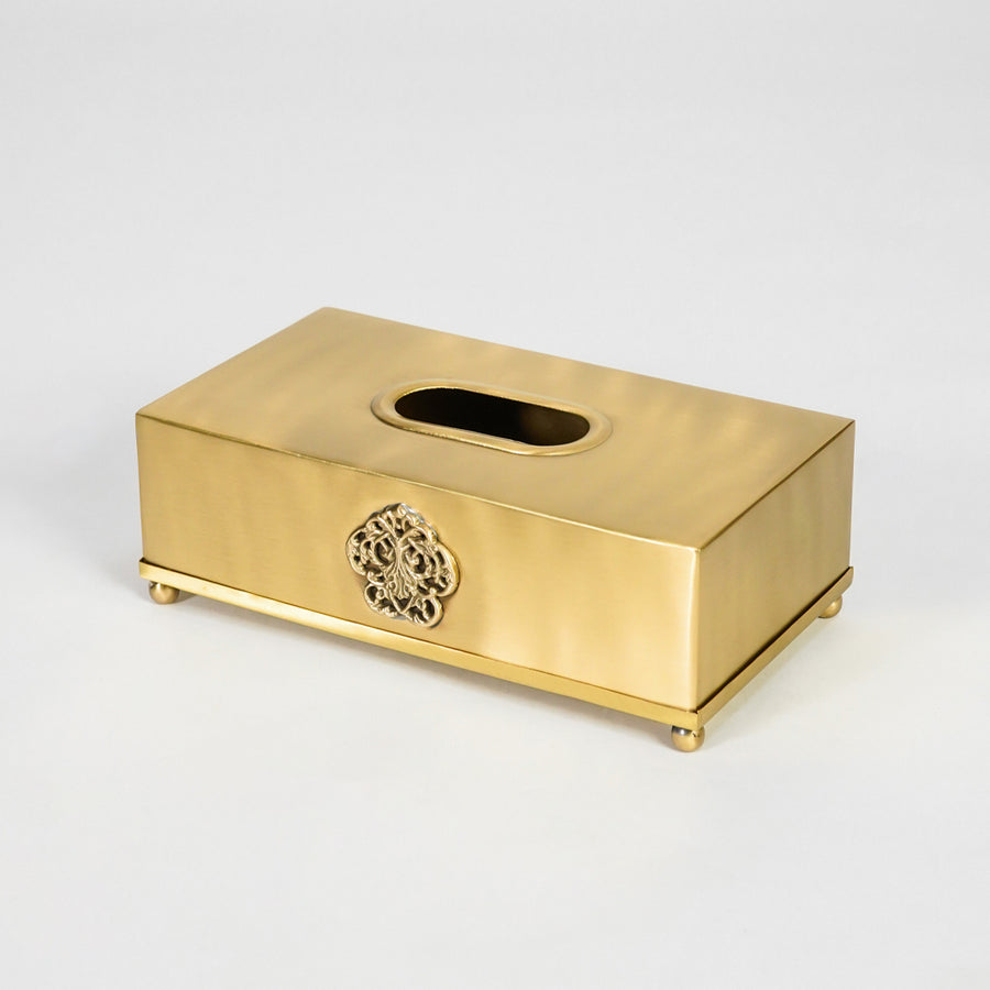 Antique gold rectangular tissue box holder with decorative emblem and smooth finish for sophisticated interiors.