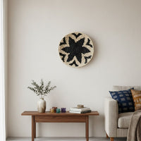 Woven wall basket styled above wooden console with decor accents creating warm natural focal point for modern living room Decor.