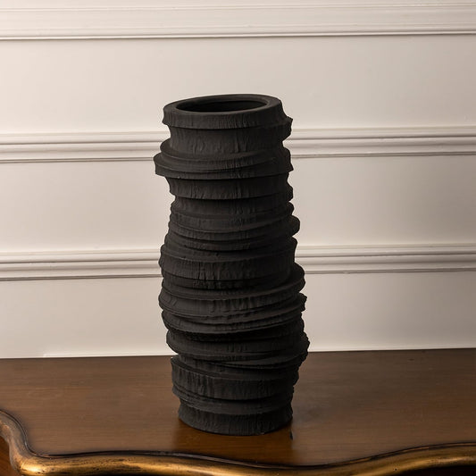 Tall black ceramic vase with sculptural layered texture shown on white background for modern decor inspiration.