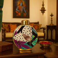 Butterfly ceramic jar with hand-painted butterfly art placed on a classic wooden table in a warm traditional living room setting.