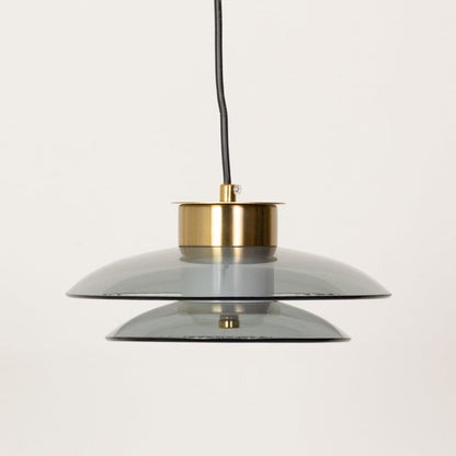 Pair of grey and amber pendant lights shown with lights off highlighting the layered glass design and contemporary round form.