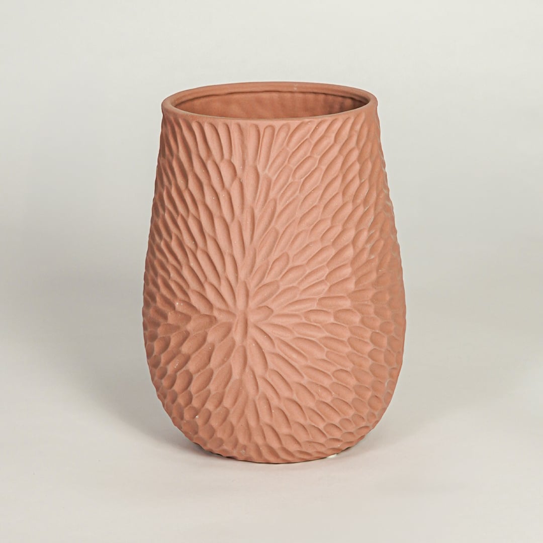 Modern green ceramic sculptural flower vase with twin openings isolated on white background for clean product display.