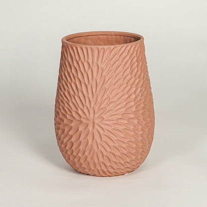 Modern green ceramic sculptural flower vase with twin openings isolated on white background for clean product display.