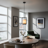 Modern black pendant light with fabric shade for elegant dining room lighting and interior decor styling.
