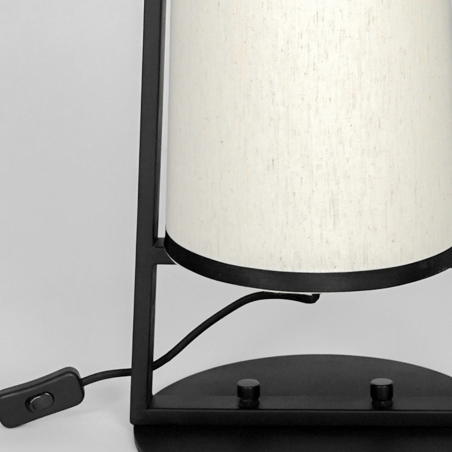 Closeup image of sleek metal table lamp for elegant bedroom decor styling highlighting durable smooth metallic finish detail.