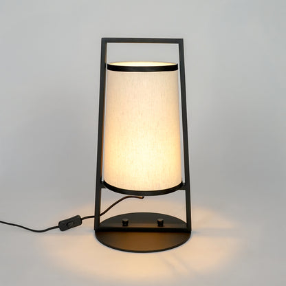 White background image of illuminated metal table lamp for elegant bedroom decor styling and modern home lighting interior.
