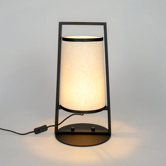 White background image of illuminated metal table lamp for elegant bedroom decor styling and modern home lighting interior.