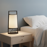 Black metal table lamp with white fabric shade for elegant modern bedside lighting decor styling ideas.