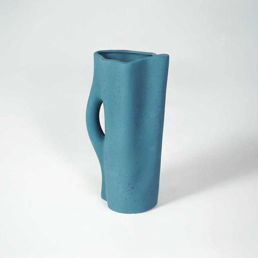 White background image of blue ceramic abstract vase for modern tabletop decor styling with matte finish.