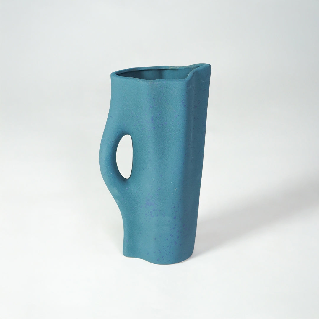 White background image of blue ceramic modern vase for contemporary interior decor styling with artistic finish.