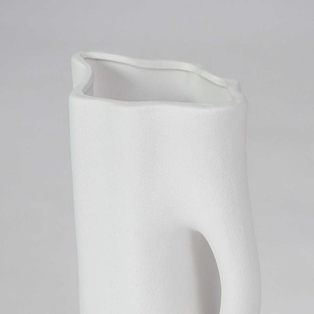 Closeup image of white ceramic abstract jug vase for modern tabletop decor styling with smooth matte finish.