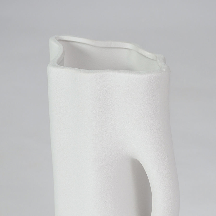 Closeup image of white ceramic abstract jug vase for modern tabletop decor styling with smooth matte finish.