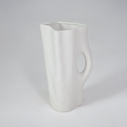White background image of white ceramic decorative vase for modern shelf placement with artistic matte finish.