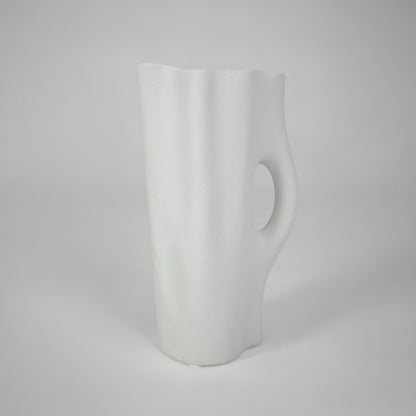 White background image of white ceramic handle vase for elegant tabletop decor styling with smooth matte finish.