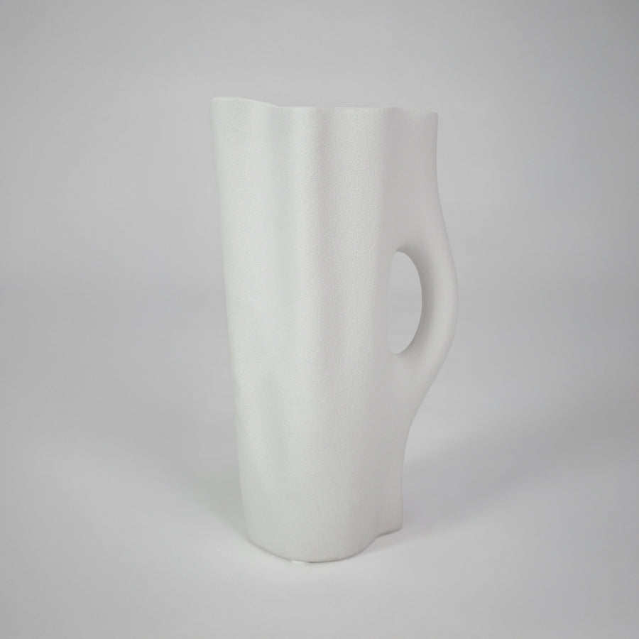 White background image of white ceramic handle vase for elegant tabletop decor styling with smooth matte finish.