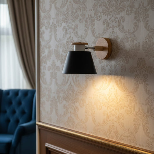 Modern black metal wall light with warm glow for luxury bedroom and contemporary home decor spaces.