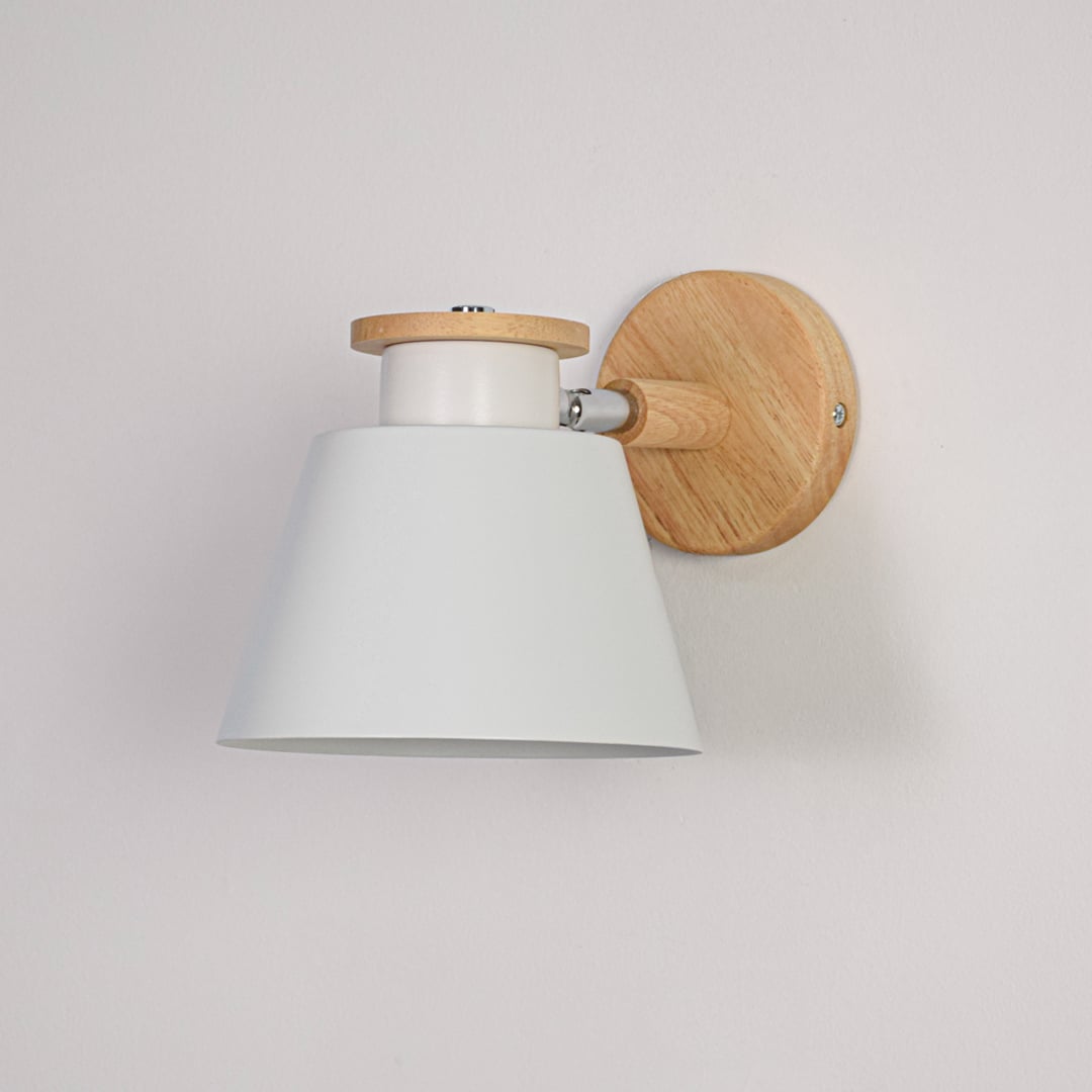 White background closeup of Scandinavian wall light showing matte white shade natural wooden mount and compact design ideal for modern minimal interiors.