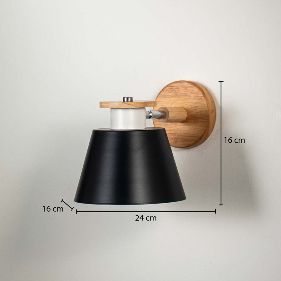 Modern black metal shade wall light with wooden base mounted on white wall background ideal for minimalist bedroom or living space lighting.