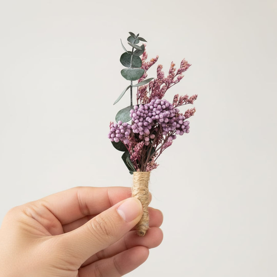 Dried flower mini bouquet with pink purple and green preserved florals held in hand perfect for decor gifting and styling use.