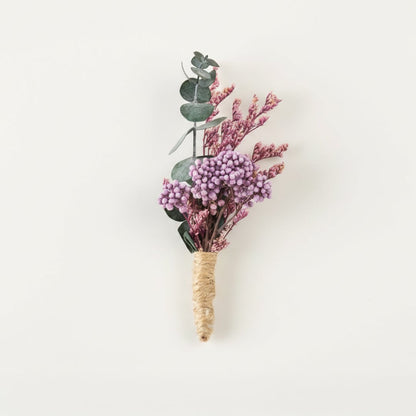 Dried floral stem bouquet with lavender buds eucalyptus leaves and pink accents on white background highlighting soft textures natural elegance and decor styling charm.