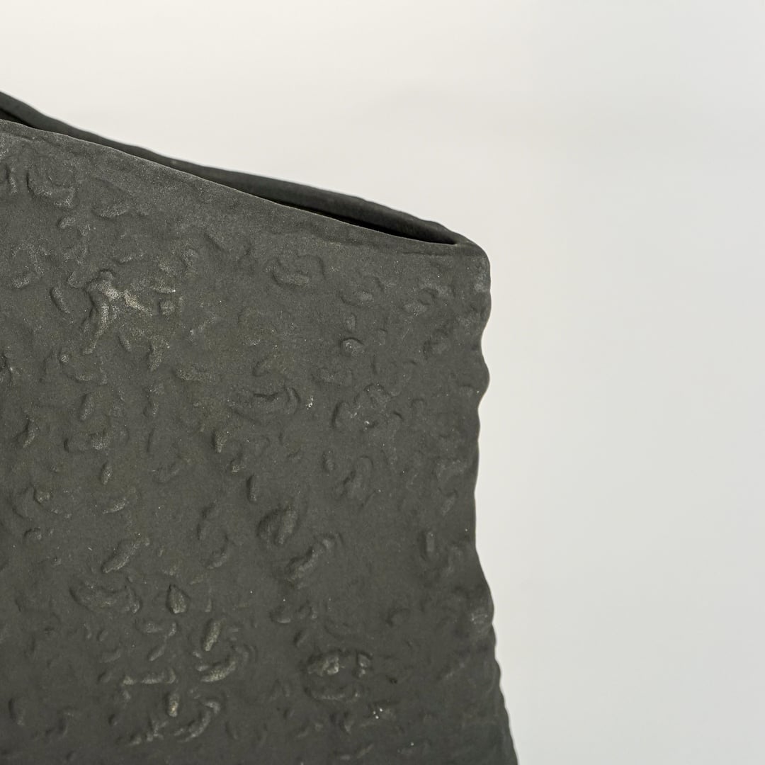 tombstone black ceramic vase closeup 1
