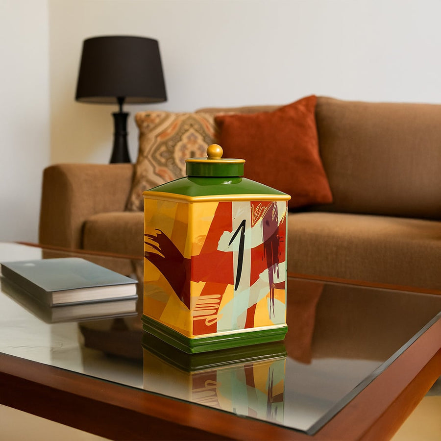 Abstract design jar displayed on a modern glass table adding a pop of color and artistic flair to home decor.