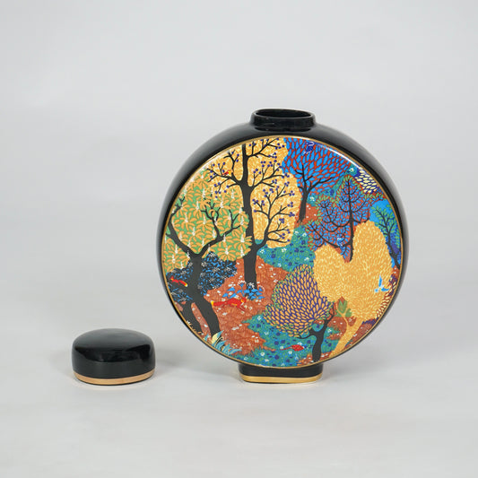 Round ceramic decorative jar with matching lid and colorful abstract artwork for elegant tabletop home decor displays.