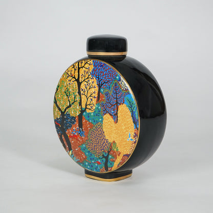 Round ceramic decorative jar with vibrant artistic pattern for sophisticated shelf styling and contemporary home decor.