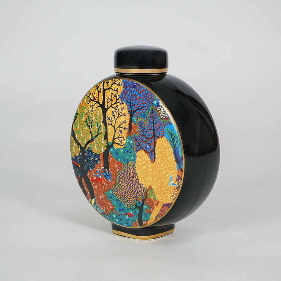 Round ceramic decorative jar with vibrant artistic pattern for sophisticated shelf styling and contemporary home decor.