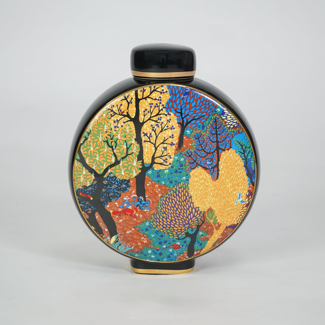 Round ceramic decorative jar with colorful abstract artwork for contemporary shelf styling and modern home decor.