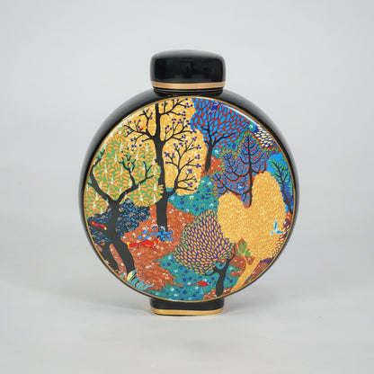 Round ceramic decorative jar with colorful abstract artwork for contemporary shelf styling and modern home decor.