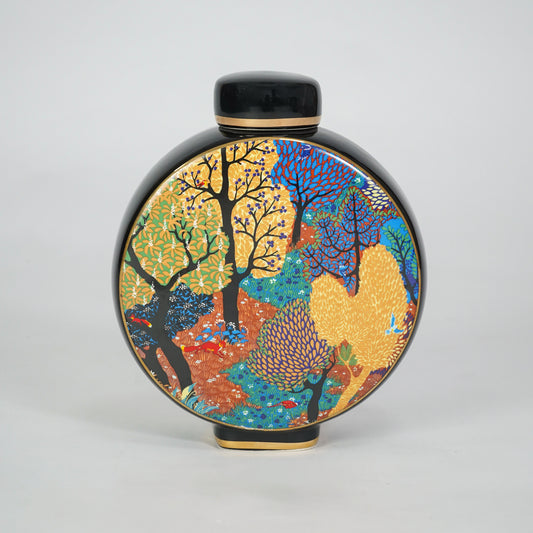 Round ceramic decorative jar with colorful abstract artwork for contemporary shelf styling and modern home decor.