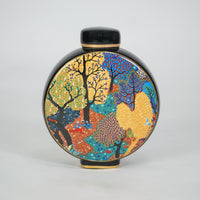 Round ceramic decorative jar with colorful abstract artwork for contemporary shelf styling and modern home decor.