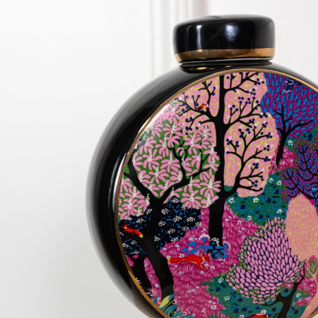 Closeup of decorative round vase featuring vibrant multicolor tree artwork glossy finish and artistic handcrafted design detail.