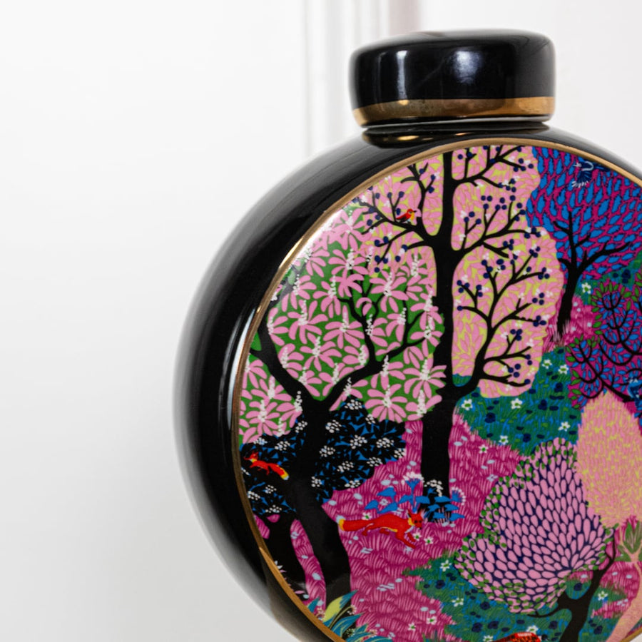 Closeup of decorative round vase featuring vibrant multicolor tree artwork glossy finish and artistic handcrafted design detail.