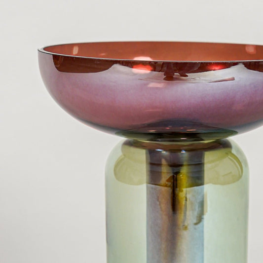 Close up view multicolor glass pedestal vase showing glossy finish artistic glass form luxury decorative accent for shelf styling.