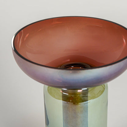 Close up view multicolor art glass vase with pedestal base showing smooth texture decorative glass accent for modern shelf styling.