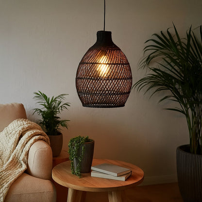 Black woven rattan pendant light adding a warm natural accent to modern interiors with its artistic handwoven organic design.